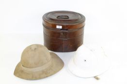 A tin hat box with original early polo helmet and an early pith helmet