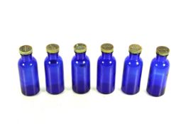 A set of six Salvitae American Apothecaries of New York blue glass bottles