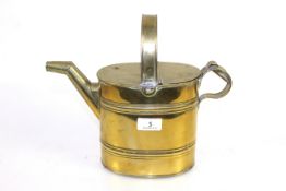 A small brass watering can
