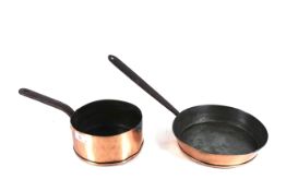An early copper frying pan with metal handle and a copper saucepan with metal handle