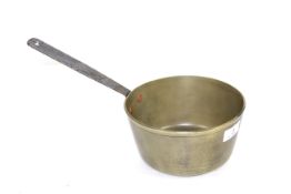 A medium size brass jam makig saucepan with a ste