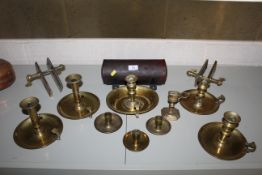 A large collection of antique and vintage brass chamber sticks, tinware candle box, brass snuffer