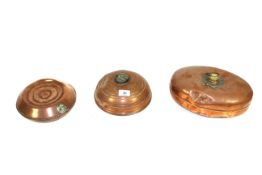 Three copper bed warmers
