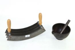 A cast iron pestle and mortar and a large herb cutter