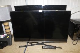 A Samsung flat screen television and remote contro