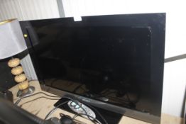 A Sony flat screen television and remote control