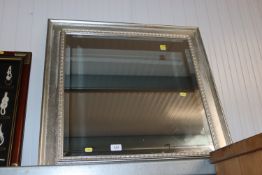 A modern framed and bevel edge wall mirror