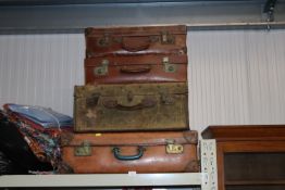 Four vintage suitcases, some initialled