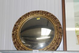 A gilt framed convex wall mirror
