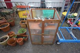 A greenhouse cupboard, lacking lid, a small quanti