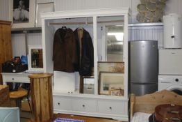 A modern triple wardrobe fitted three drawers