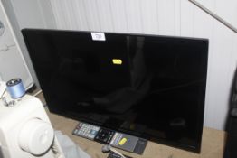 A Toshiba flat screen television and remote contro