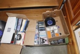 Three boxes containing cassettes and records etc.