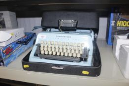 A Scheidegger Typomatic typewriter and case