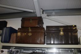 Three tin trunks together with a leather bag and a suitcase
