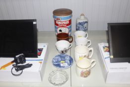 A quantity of commemorative mugs, a commemorative glass ashtray, a Delft blue and white flask, a