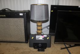 A Sony docking station, together with a table lamp