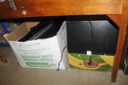 Two boxes containing various computer monitors, so