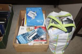 A box containing various books and a BT phone, tog