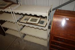 A white painted metal four tier shelving unit