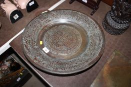 A copper Islamic decorated metal charger