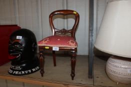 A miniature upholstered dining chair