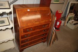 A walnut veneered bureau fitted four drawers