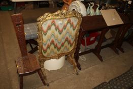 An antique needlework gilt firescreen