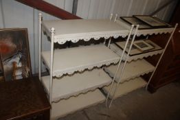 A white painted metal four tier shelving unit