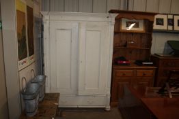 A white painted pine two door wardrobe fitted sing