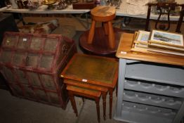A nest of three leather topped occasional table to