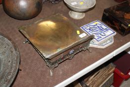 A brass bible rest with enamel plaque and red ston