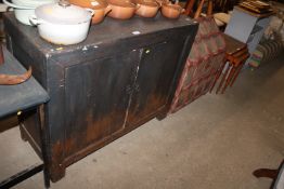 A stained pine two door sideboard