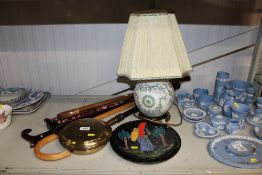 A brass warming pan; two pottery plates; a table l