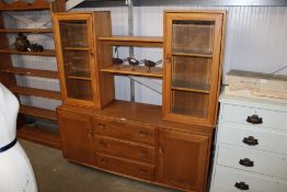 An Ercol display cabinet fitted three drawers flan