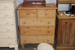 A stripped pine chest fitted two short over three