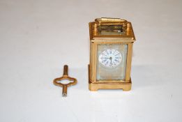 A miniature gilt Sevres style carriage clock