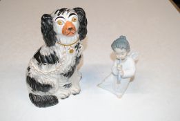 A Staffordshire spaniel and a Lladro figure in the