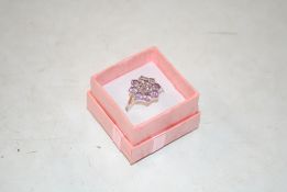 A sterling silver and amethyst set dress ring , si