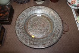 A copper Islamic decorated metal charger