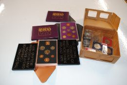 A box containing six coin packs and various other