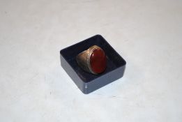 A vintage white metal ring set with coloured stone
