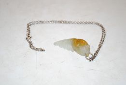 A vintage silver chain with a jade pendant in the