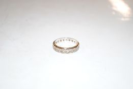 A 9ct gold eternity ring, set with white stones, r