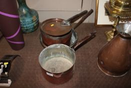 Three copper saucepans one with lid