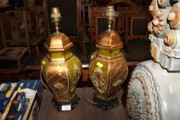 A pair of gilt decorated table lamps raised on woo