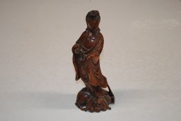 A Chinese carved wooden figure of Quan Yin