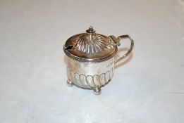 A silver mustard pot
