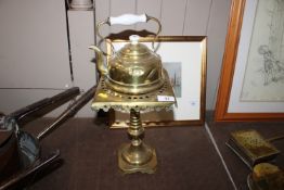 A brass kettle with porcelain handle and a brass t