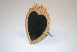 A gilt heart shaped photo frame